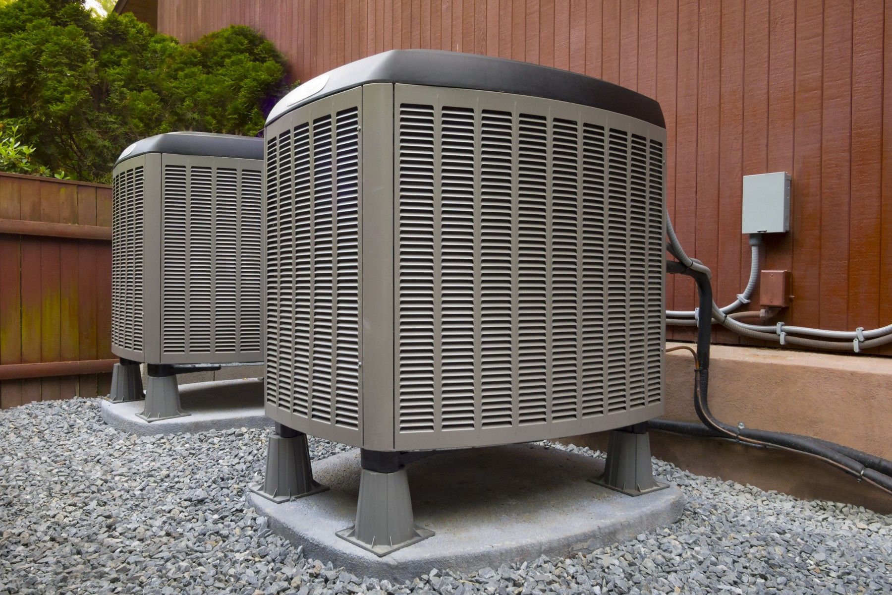 Residential AC condenser units outside a home